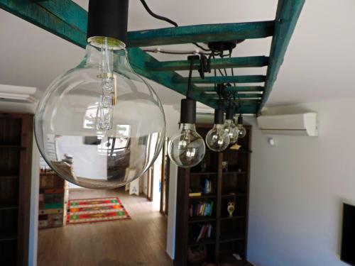 a large glass orb hanging from a ceiling at Timbuktu Hostel in San Vito lo Capo