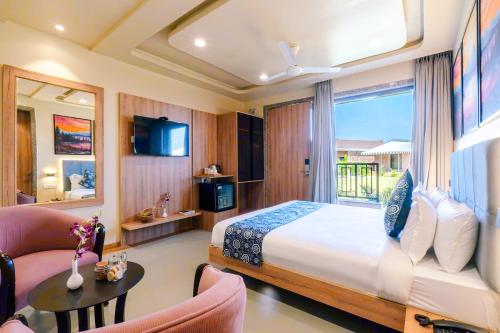 a hotel room with a bed and a couch at Imperia Resort by The Sky Imperial, Nathdwara in Nāthdwāra