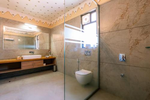a bathroom with a shower and a toilet and a sink at Imperia Resort by The Sky Imperial, Nathdwara in Nāthdwāra