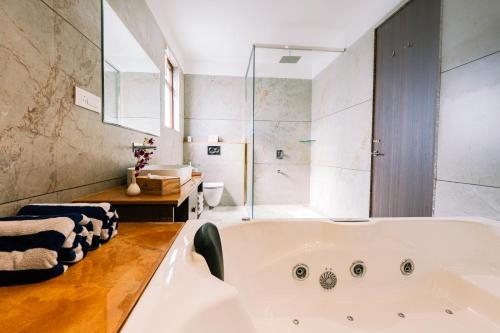 a bathroom with a large tub and a shower at Imperia Resort by The Sky Imperial, Nathdwara in Nāthdwāra