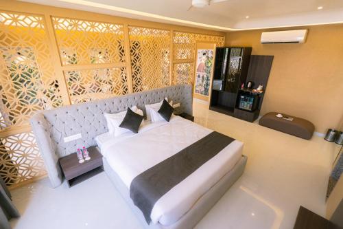 a bedroom with a large white bed with pillows at Imperia Resort by The Sky Imperial, Nathdwara in Nāthdwāra
