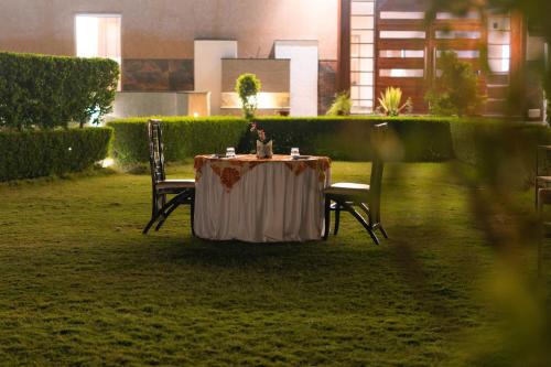 a person sitting at a table in a garden at Imperia Resort by The Sky Imperial, Nathdwara in Nāthdwāra