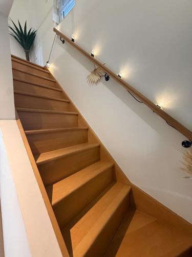 a staircase in a house with wooden floors and lights at Capstay hyper Centre Arras in Arras