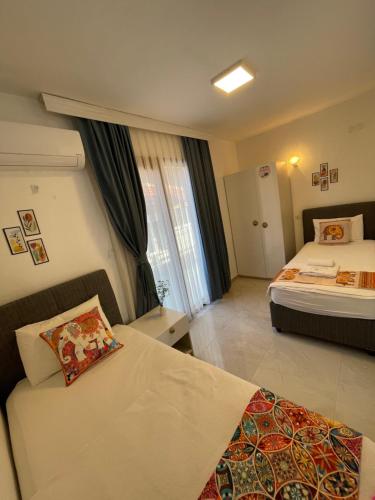 Postel nebo postele na pokoji v ubytování Özdemir Otel Datça