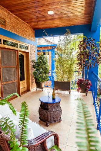 a patio with a table and chairs and plants at Maison Ubururu in Kigali