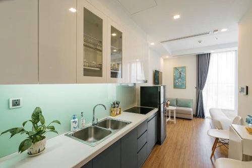 una cocina con fregadero y refrigerador en The Matrix One Luxury Apartment Hà Nội, en Hanói