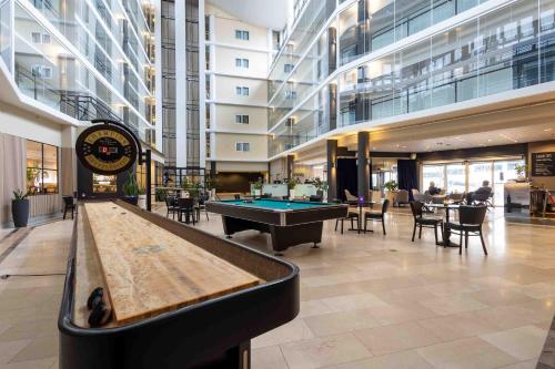 a lobby with a pool table in a building at Injoy Compact Hotel Solna in Solna