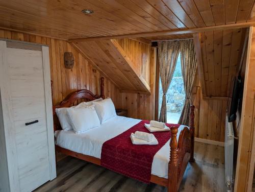 a bedroom with a bed in a wooden room at Casa Letca montain in Sohodol