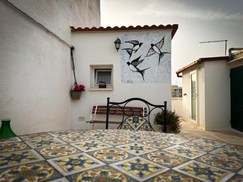 a bedroom with a bed and a painting on the wall at Riflessi di Puglia in Martina Franca