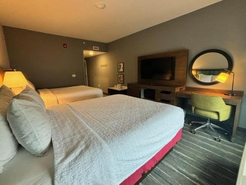 a hotel room with a large bed and a desk at Hampton Inn & Suites Deptford, Nj in Deptford