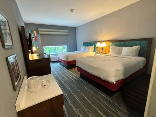 a large hotel room with two beds and a table at Hampton Inn & Suites Deptford, Nj in Deptford