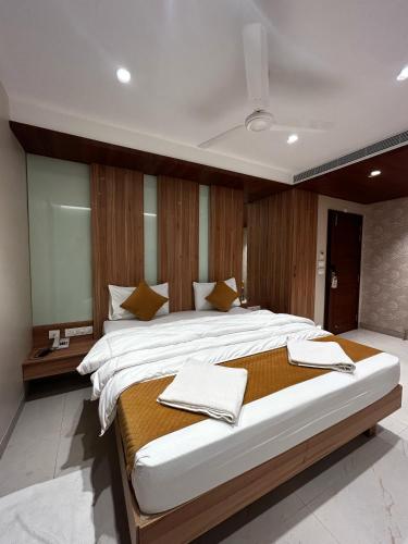a large bedroom with a large bed with wooden walls at The Paradise Kingdom in Kanchipuram