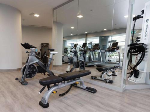 a gym with several exercise bikes and mirrors at Hilton Diagonal Mar Barcelona in Barcelona