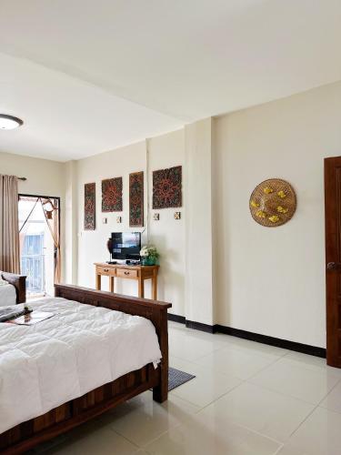 a bedroom with a bed and a television in it at candy house ที่พักวัวลาย เชียงใหม่ in Chiang Mai