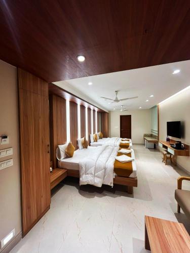 a large bedroom with a large bed and a television at The Paradise Kingdom in Kanchipuram