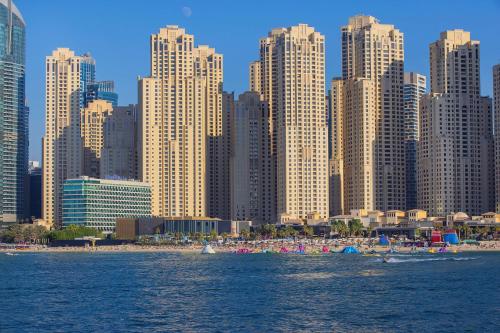 a view of a city with a beach and tall buildings at Hilton Dubai The Walk in Dubai