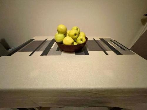 a bowl of green apples on a table at Milva B&B in Casalecchio di Reno