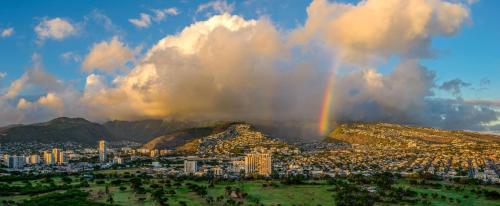 a city with a rainbow in the sky at Hilton Waikiki Beach Resort & Spa in Honolulu