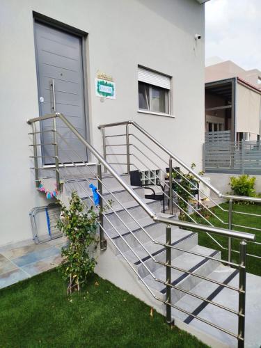 a set of stairs in front of a house at Aloha Inn in Artemida