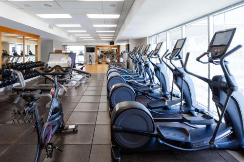 a gym with a row of treadmills at Hilton Americas - Houston in Houston
