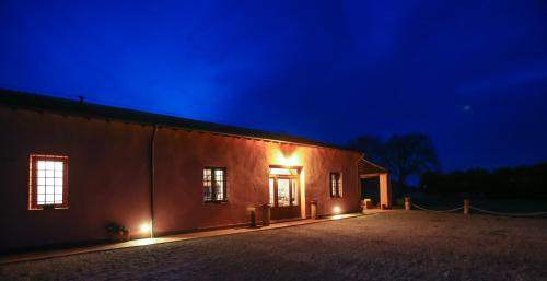 a building with lights on the side of it at night at Agriturismo Ristorante Monte Argentario in Monte Argentario