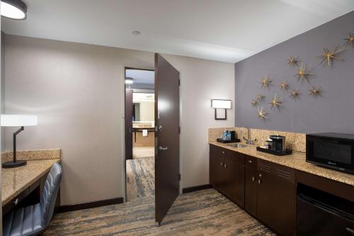 a hotel room with a bathroom with a sink at Hilton Americas - Houston in Houston