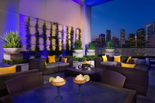 a restaurant with couches and tables and a city skyline at Hilton Americas - Houston in Houston