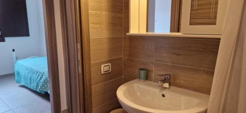 a bathroom with a toilet and a sink at Arbatax Apartment in Àrbatax