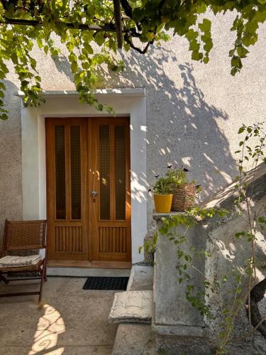 a wooden door of a house with a bench at Casa della Nonna in Škrljevo