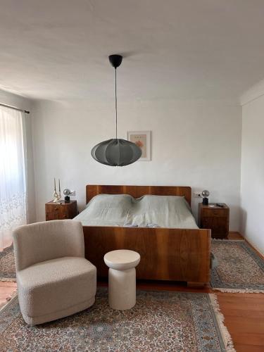 a bedroom with a bed and a chair and a lamp at Casa della Nonna in Škrljevo