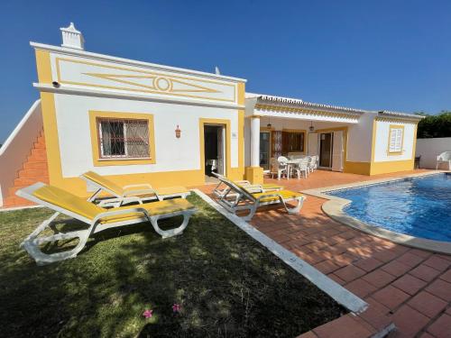 a villa with a swimming pool and a house at Villa Ana in Albufeira