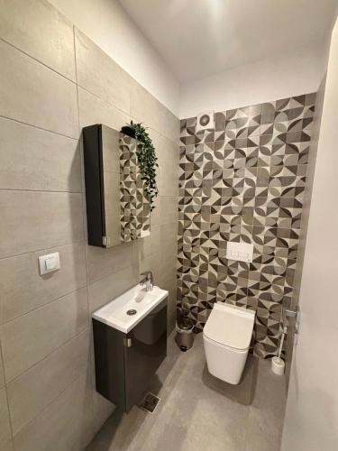 a bathroom with a toilet and a sink at Sunrise Apartments - Onix Pipera in Bucharest
