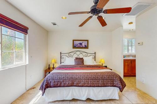 a bedroom with a bed and a ceiling fan at Cool Pool Retreat in Bermuda Dunes