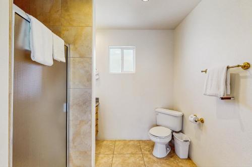 a bathroom with a toilet and a shower at Cool Pool Retreat in Bermuda Dunes