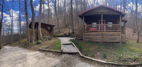 a small cabin in the middle of a forest at Campfire Cabin, Red River Gorge, KY, River Access & Views in Stanton