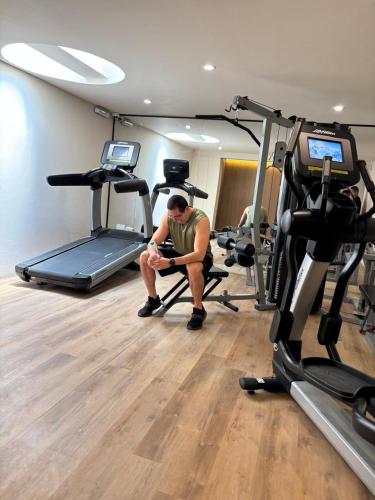 a man sitting on a chair in a gym at La Posada del Puente in Arequipa