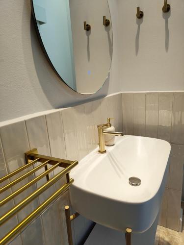 a bathroom with a white sink and a mirror at Alba in Sliema