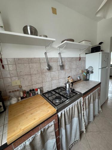 a kitchen with a stove and a refrigerator at Villa MAE Favignana in Favignana