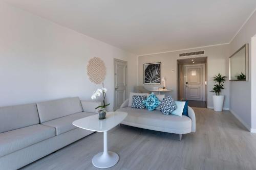 a living room with a couch and a table at Hilton Malta in St Julian's