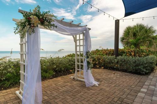 an arch for a wedding at the beach at Hilton Melbourne Beach Oceanfront in Melbourne