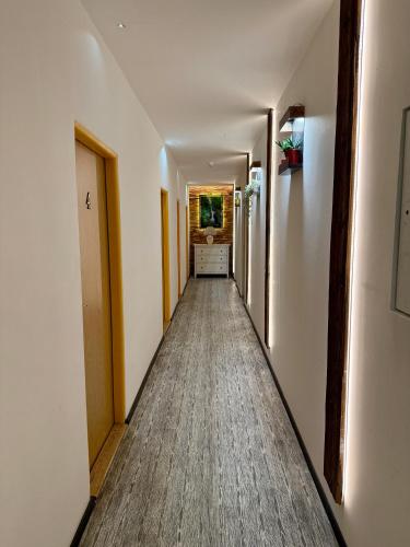 a hallway of a room with a long hallway sidx sidx at Pension SKLEP in Prague