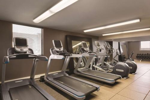 a gym with a row of cardio machines in a room at Embassy Suites by Hilton Bloomington/Minneapolis in Bloomington