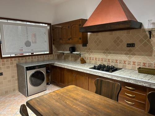 a kitchen with a table and a stove and a microwave at Blue pearl Mogador in Essaouira