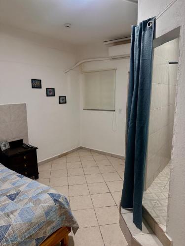 a bedroom with a bed and a chalkboard on the wall at Cuartos Lupita in Cabo San Lucas