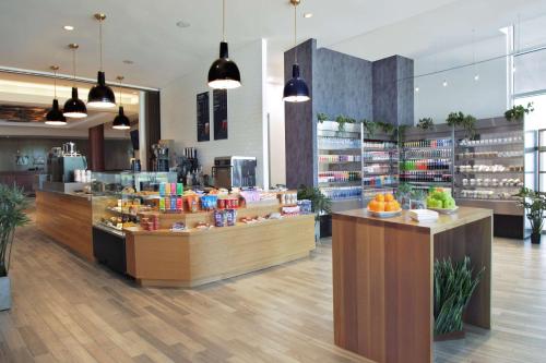 a store with a counter with fruits and vegetables at Hilton Omaha in Omaha