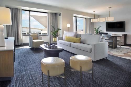a living room with a couch and a table at Hilton Omaha in Omaha