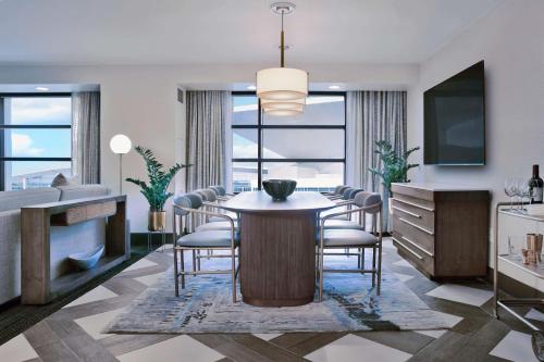 a dining room with a table and chairs at Hilton Omaha in Omaha