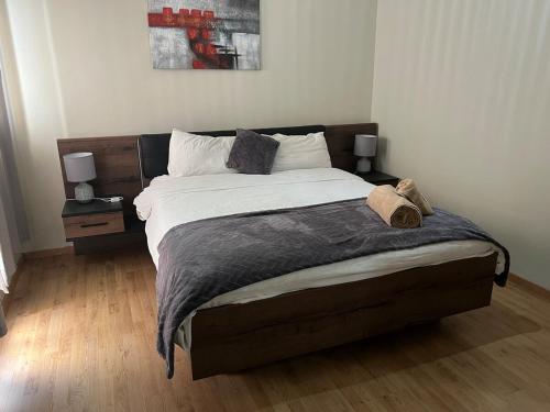 a bedroom with a large bed with two night stands at Résidence Eden in Kenitra