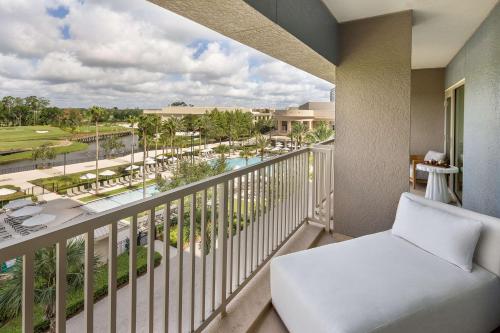 a balcony with a chair and a view of a resort at Waldorf Astoria Orlando - An Official Walt Disney World Hotel in Orlando