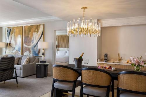 a dining room and living room with a chandelier at Waldorf Astoria Orlando - An Official Walt Disney World Hotel in Orlando